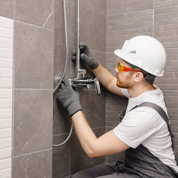 Plumber installing new shower
