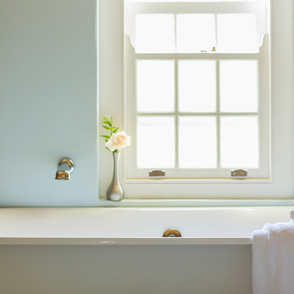 Tub below window in luxury bathroom