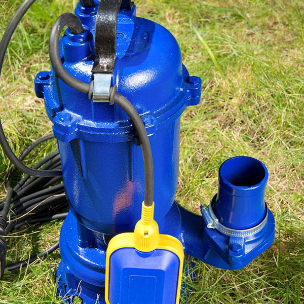 Blue submersible sewage pump removed from a residential yard for emergency repair in Ottawa, ON