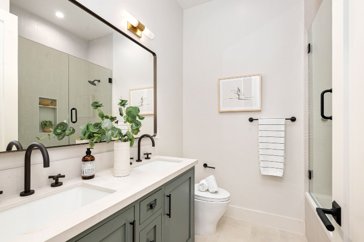 Modern bathroom with vanity, toilet, and shower in a clean interior